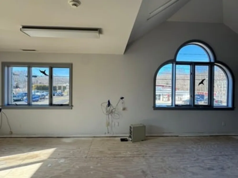 Wall painting showing prepared interior room with windows and unfinished floor